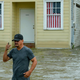 Barry Williams wading through storm surge from Lake Ponchartrain on July 13 in Mandeville, Louisiana.